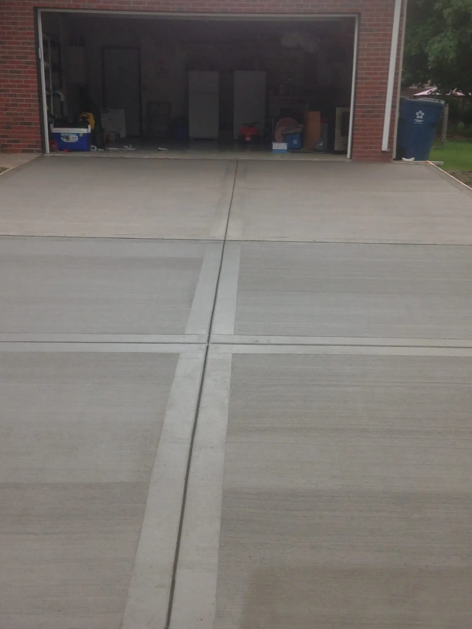 Concrete driveway with brick garage entrance